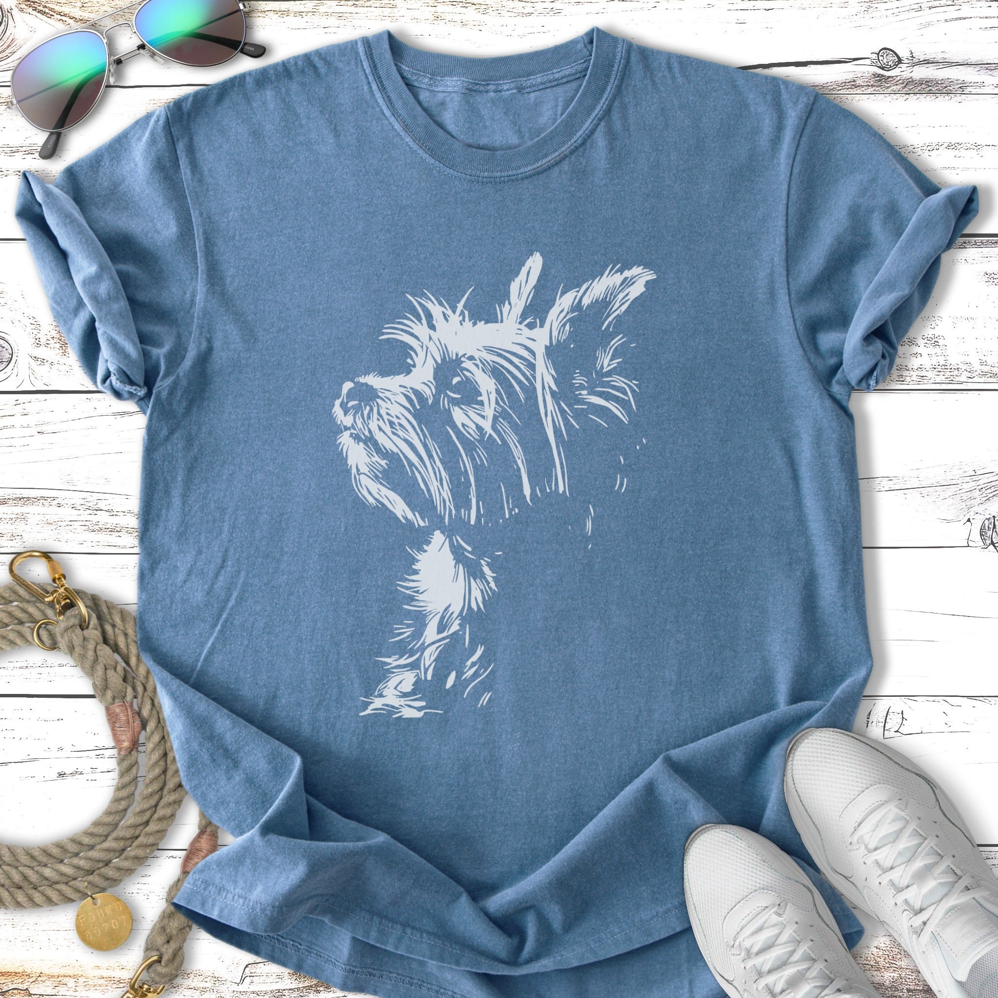 Blue t-shirt featuring a white sketched portrait of a Yorkshire Terrier dog.