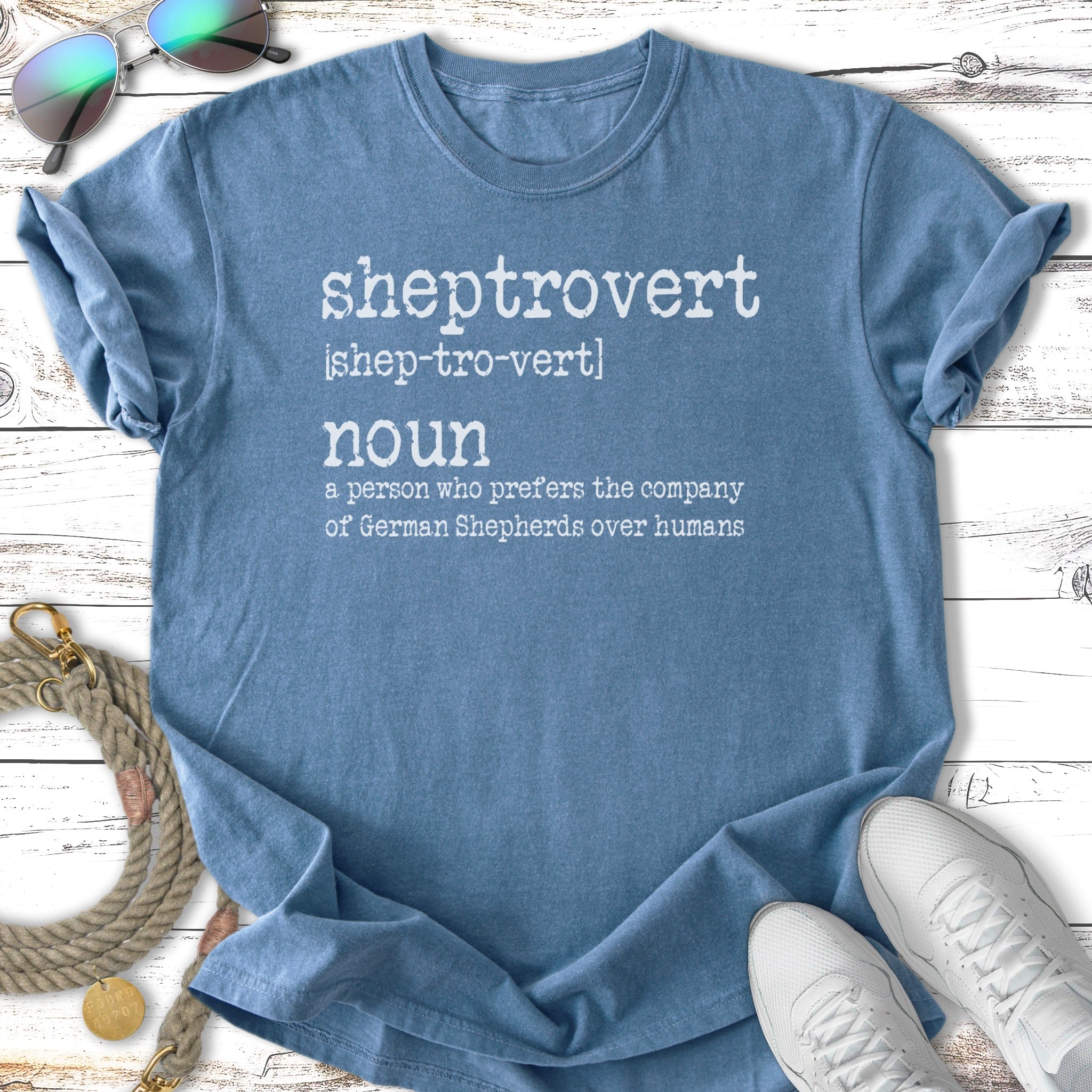 Blue t-shirt with "sheptrovert noun a person who prefers the company of German Shepherds over humans" text.