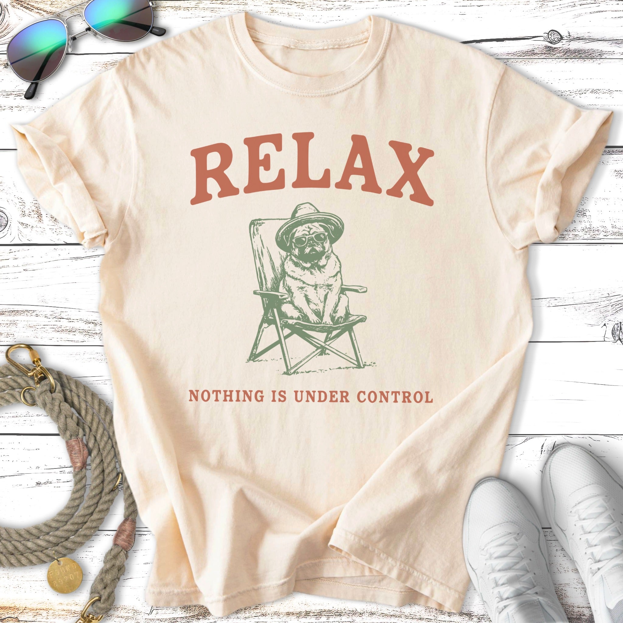 Pug in a hat sitting in a chair with text "RELAX NOTHING IS UNDER CONTROL".