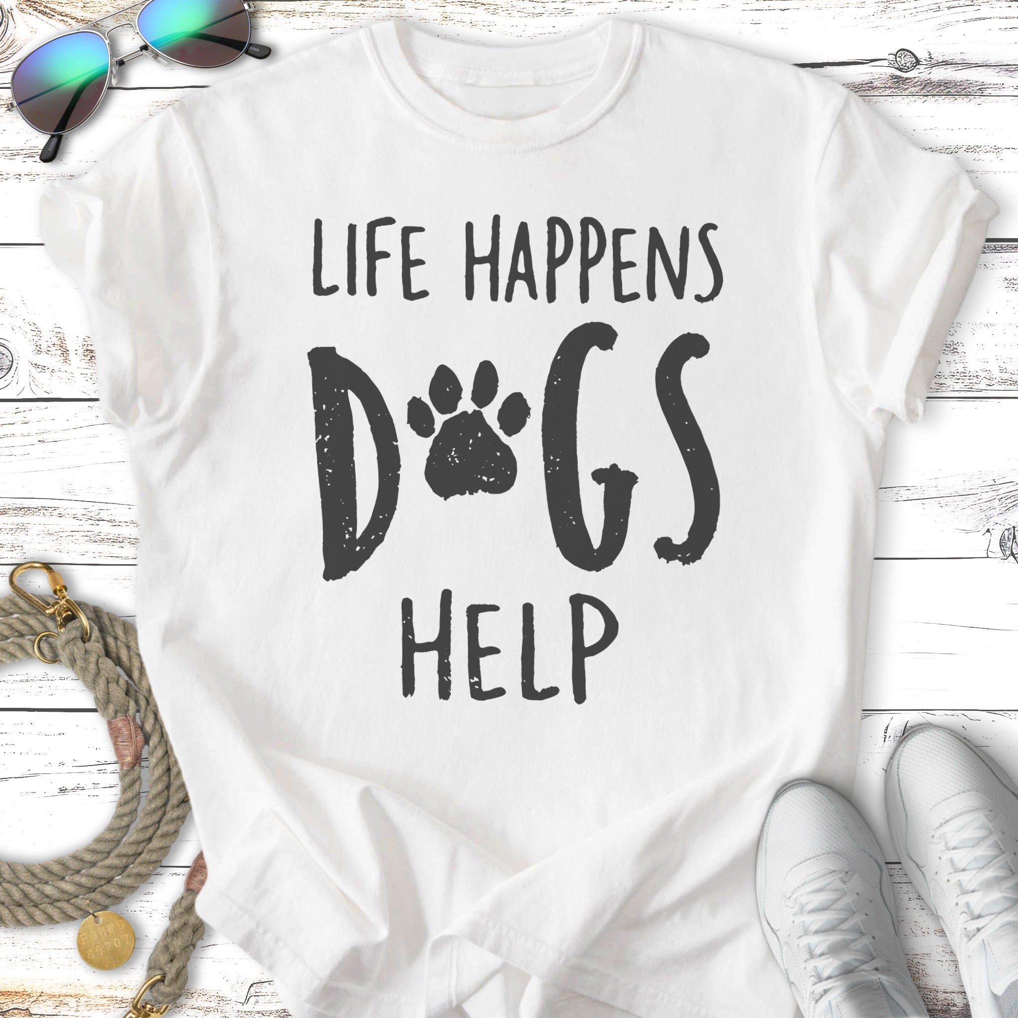 White t-shirt with distressed black text and paw print: "Life Happens Dogs Help".
