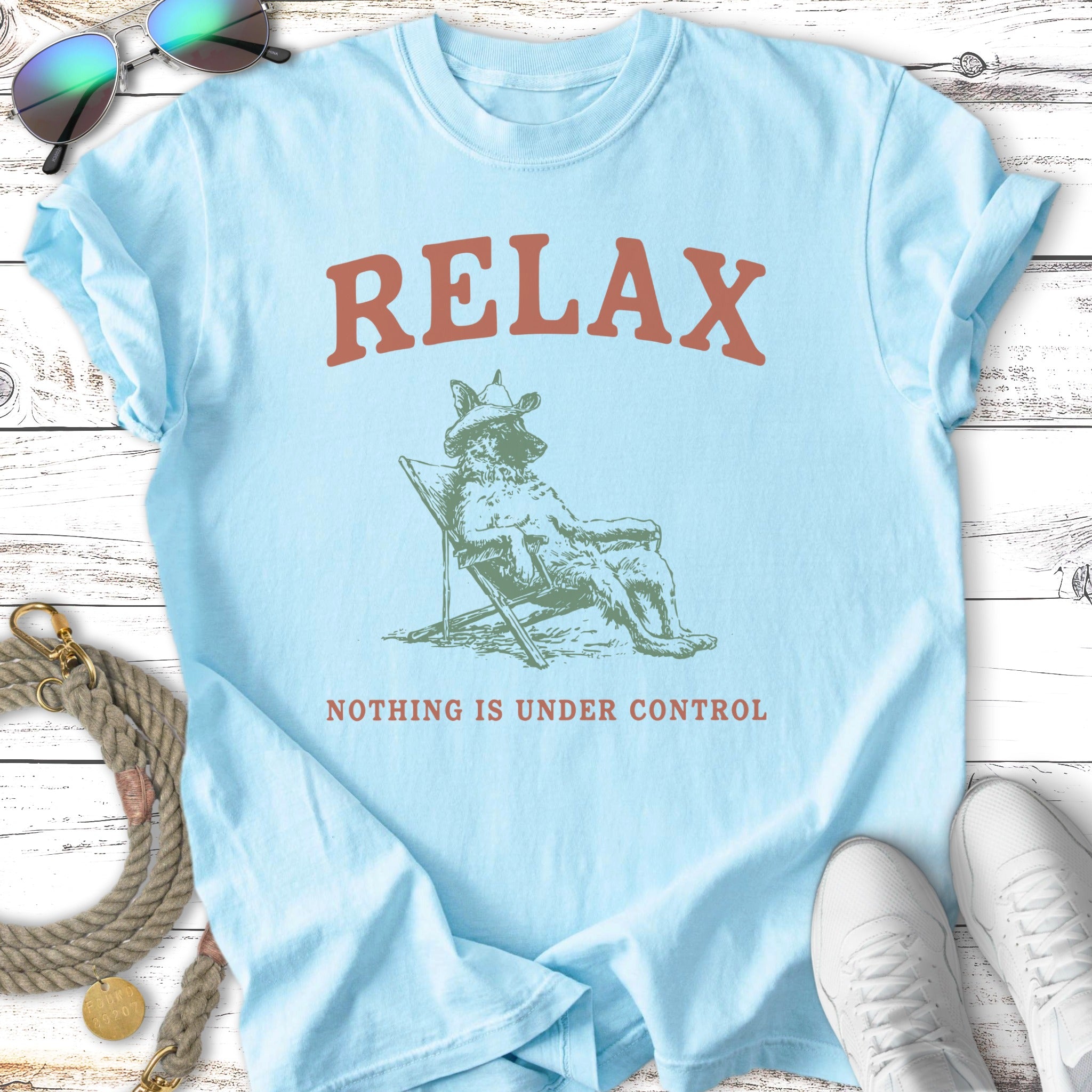 Light blue t-shirt with "RELAX" and a dog in a chair, "NOTHING IS UNDER CONTROL".