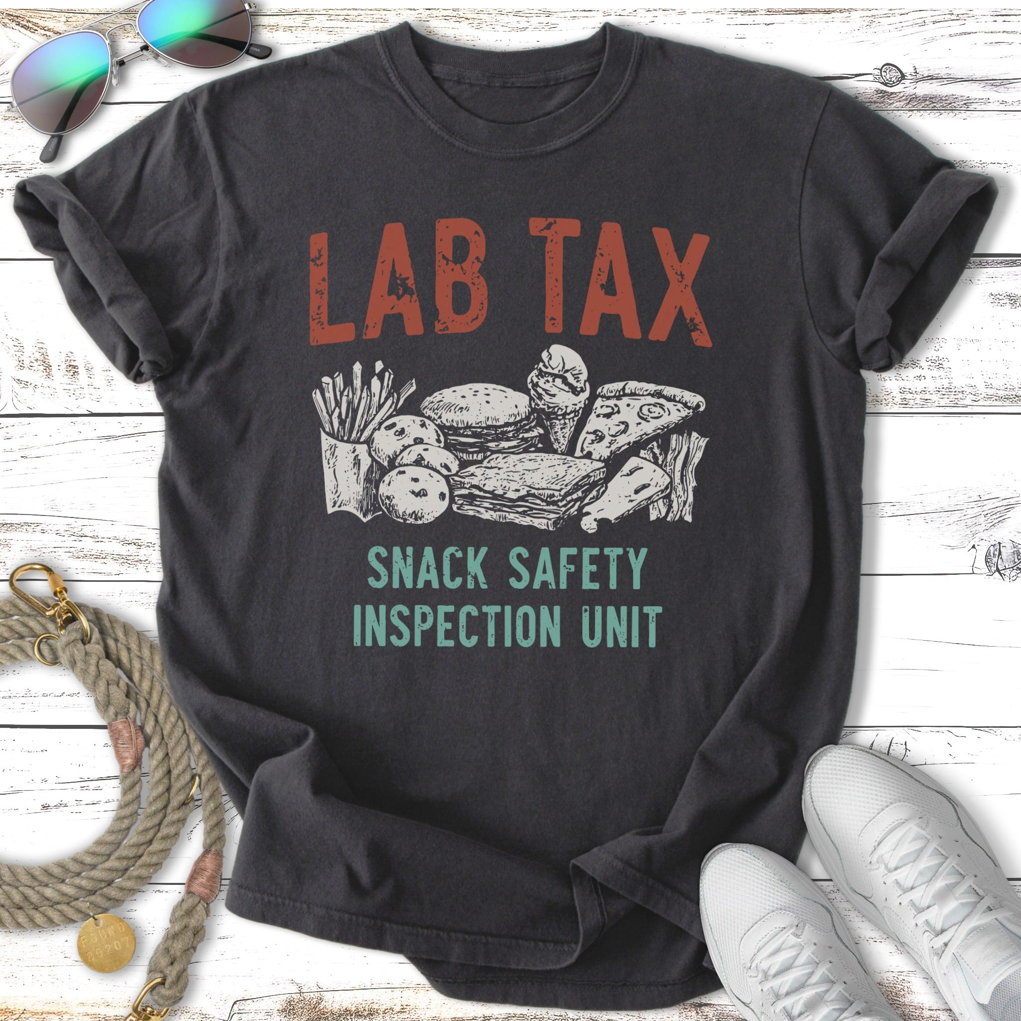 Dark t-shirt with "LAB TAX SNACK SAFETY INSPECTION UNIT" and cartoon snacks.