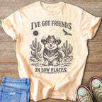Corgi wearing cowboy hat and bandana with desert graphic and text "I'VE GOT FRIENDS IN LOW PLACES".