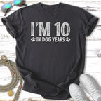 Dark grey t-shirt with "I'M 10 IN DOG YEARS" text and paw prints.
