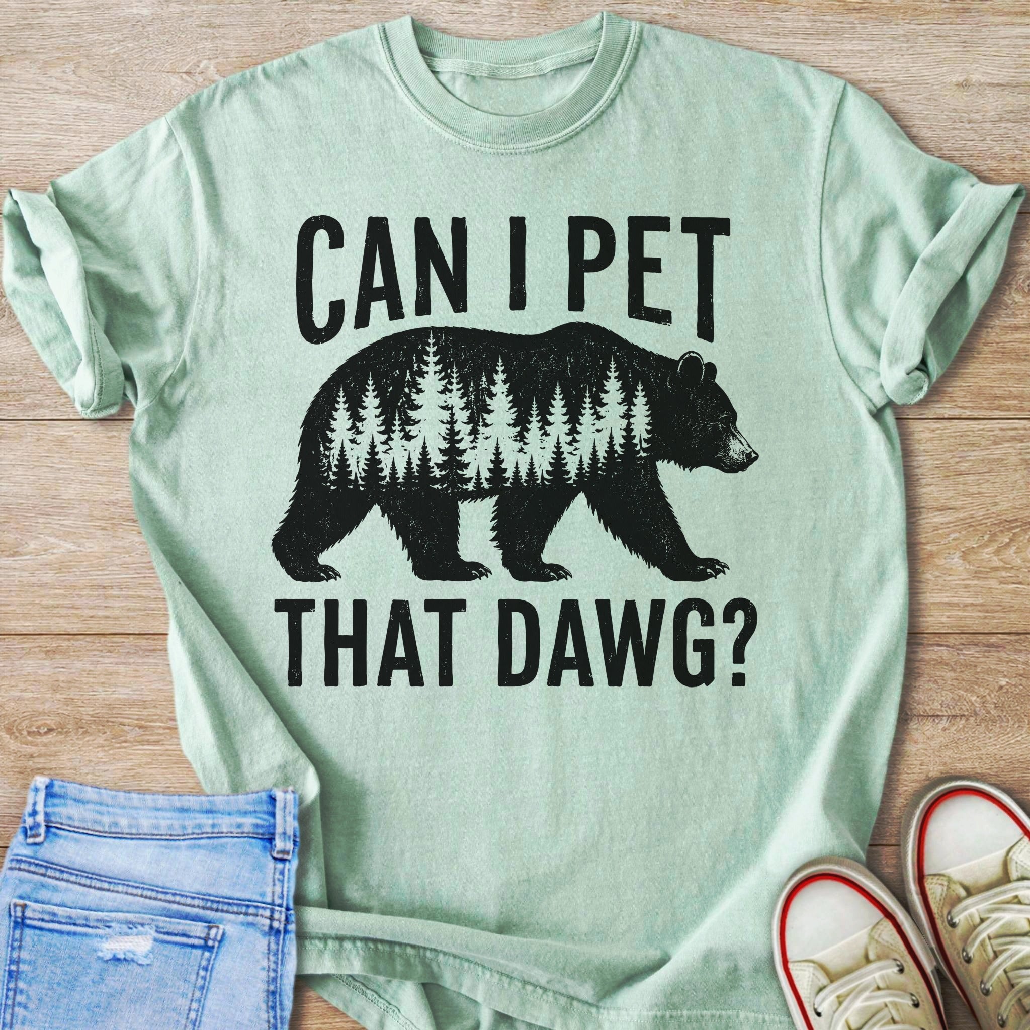 Light green t-shirt with black graphic of a bear made of trees and text.