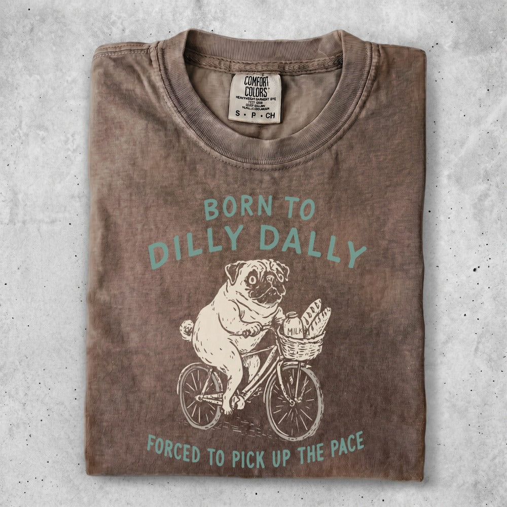 Brown t-shirt with pug on a bicycle graphic and text "Born to Dilly Dally".