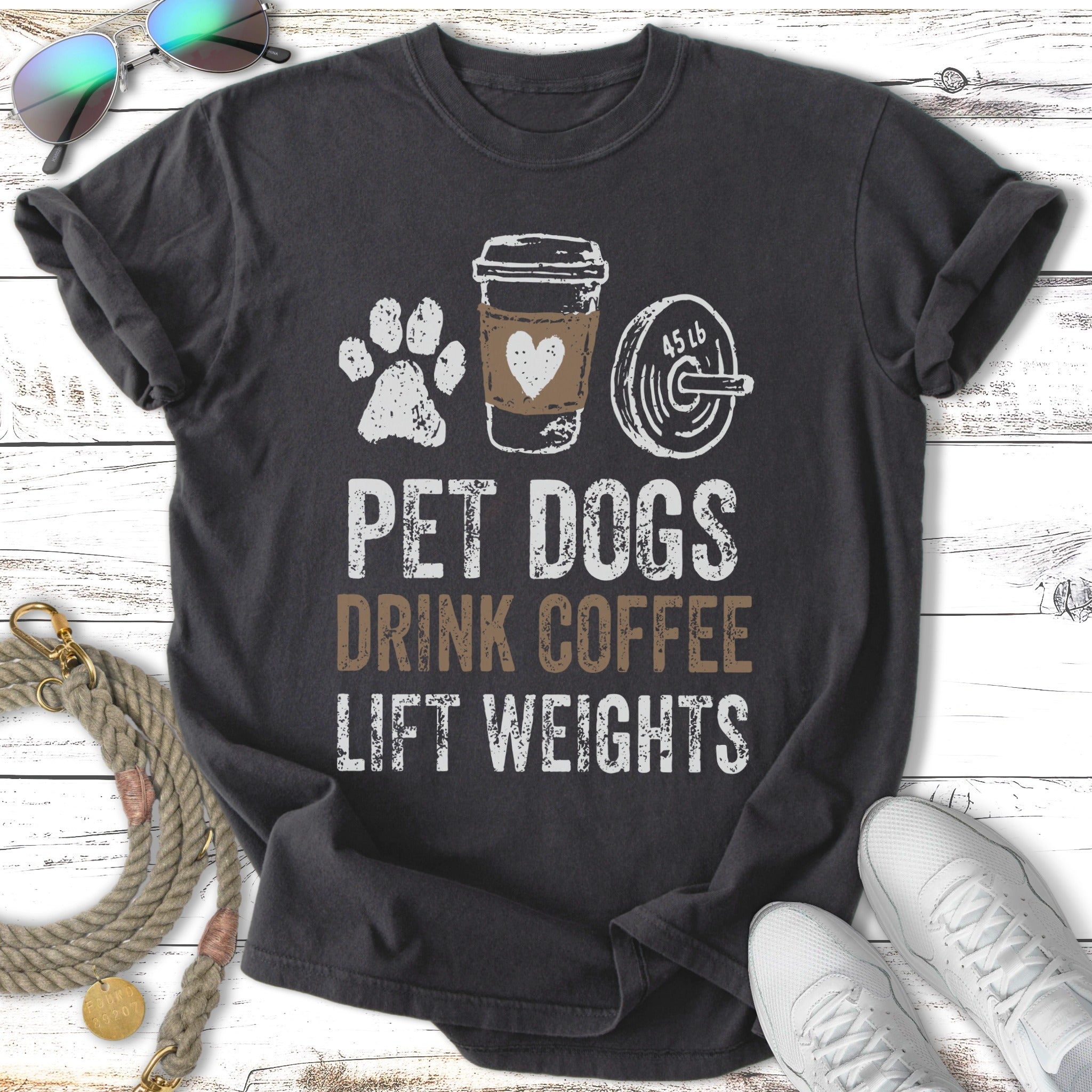 T-shirt with "Pet Dogs Drink Coffee Lift Weights" text, paw print, and dumbbell.