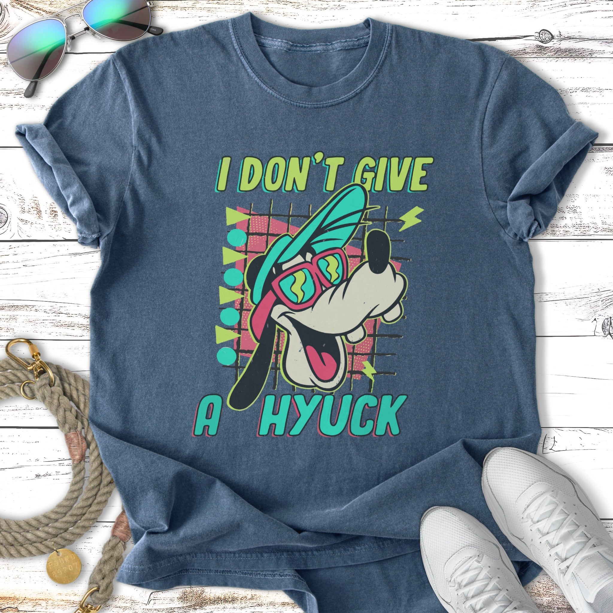 Goofy character wearing sunglasses and a hat, with text "I DON'T GIVE A HYUCK".