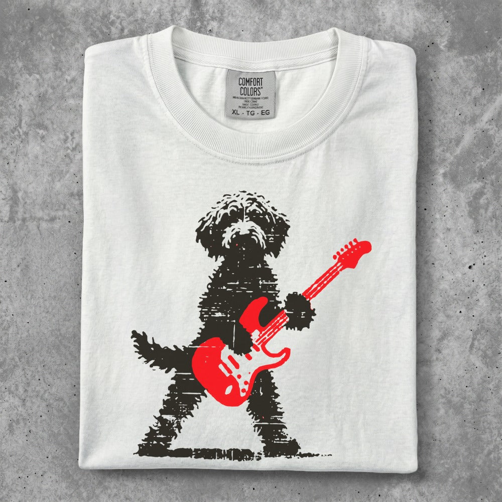 Black dog with red electric guitar printed on white t-shirt.