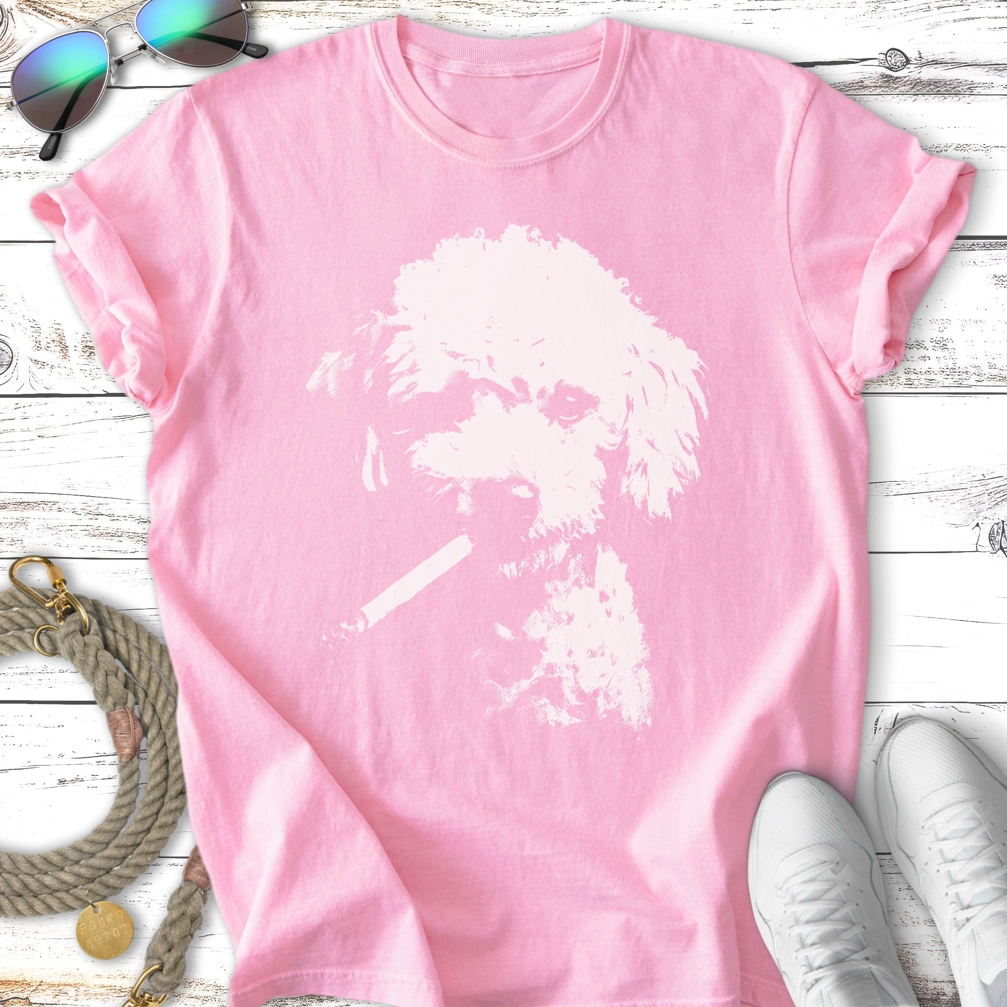 Pink t-shirt with a white graphic of a dog smoking a cigarette.