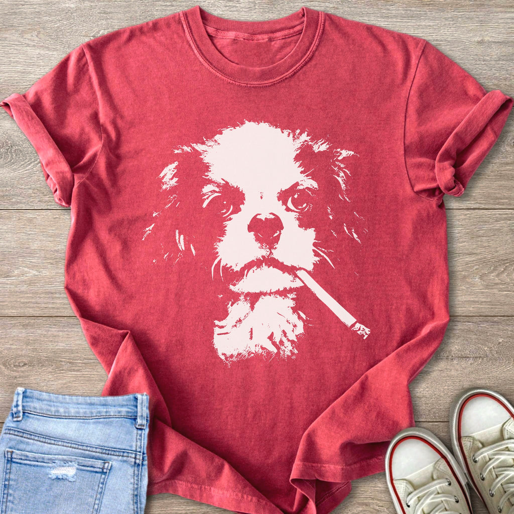 Red t-shirt with a cream-colored distressed graphic of a cavalier king charles spaniel smoking a cigarette.