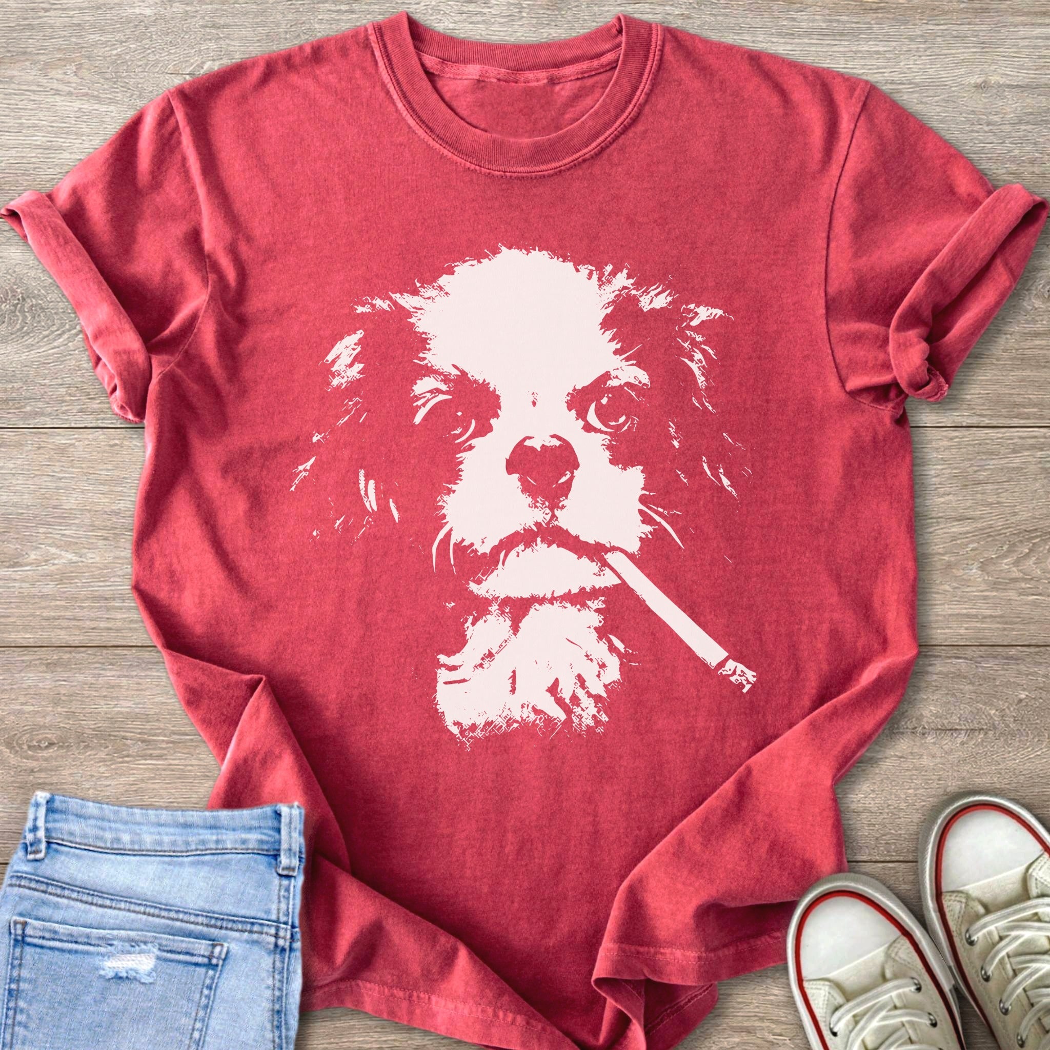 Red t-shirt with a cream-colored distressed graphic of a cavalier king charles spaniel smoking a cigarette.