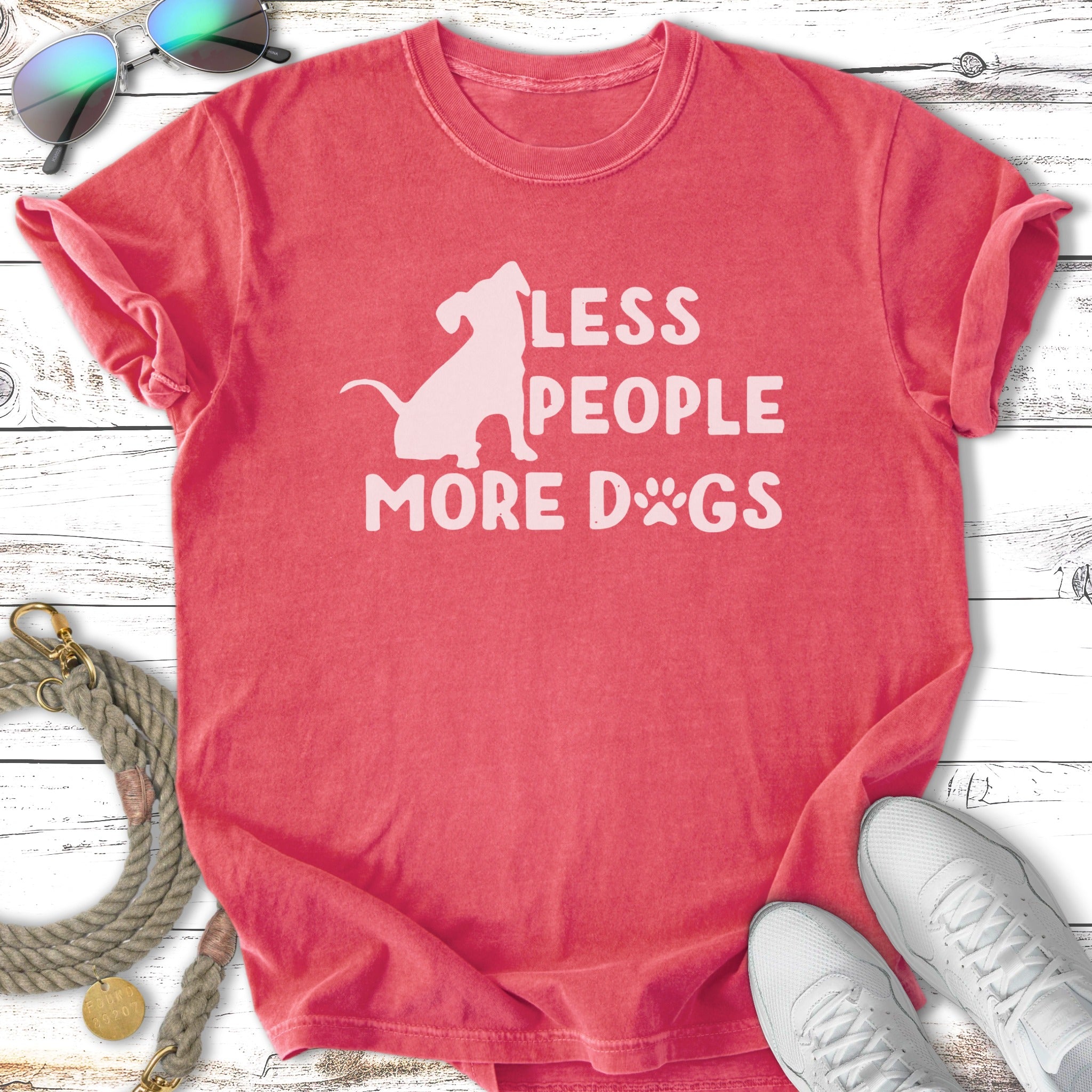 Coral t-shirt with "Less People More Dogs" graphic and dog silhouette.