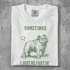 White t-shirt with green graphic of a bulldog and text "SOMETIMES I JUST BE FARTIN'".