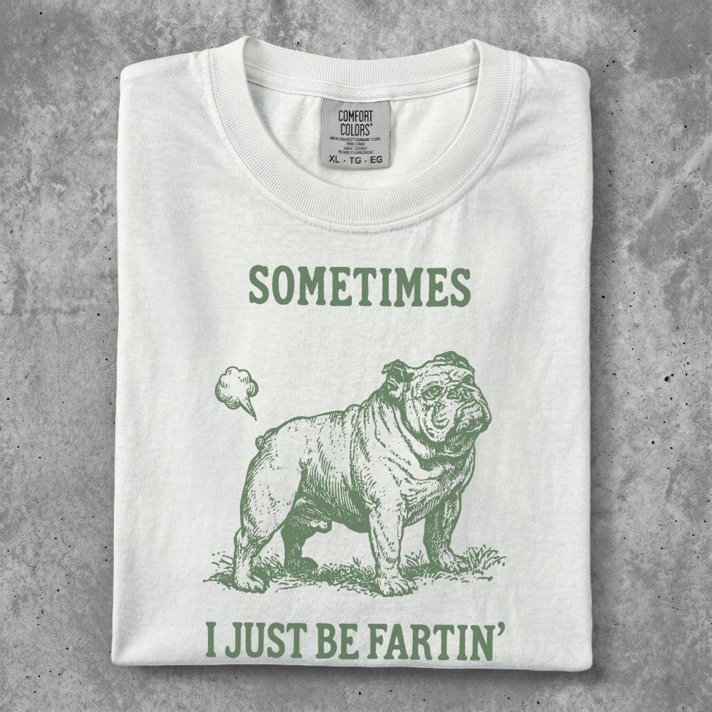 White t-shirt with green graphic of a bulldog and text "SOMETIMES I JUST BE FARTIN'".