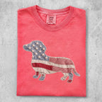 Coral t-shirt with a patriotic patchwork dachshund graphic.