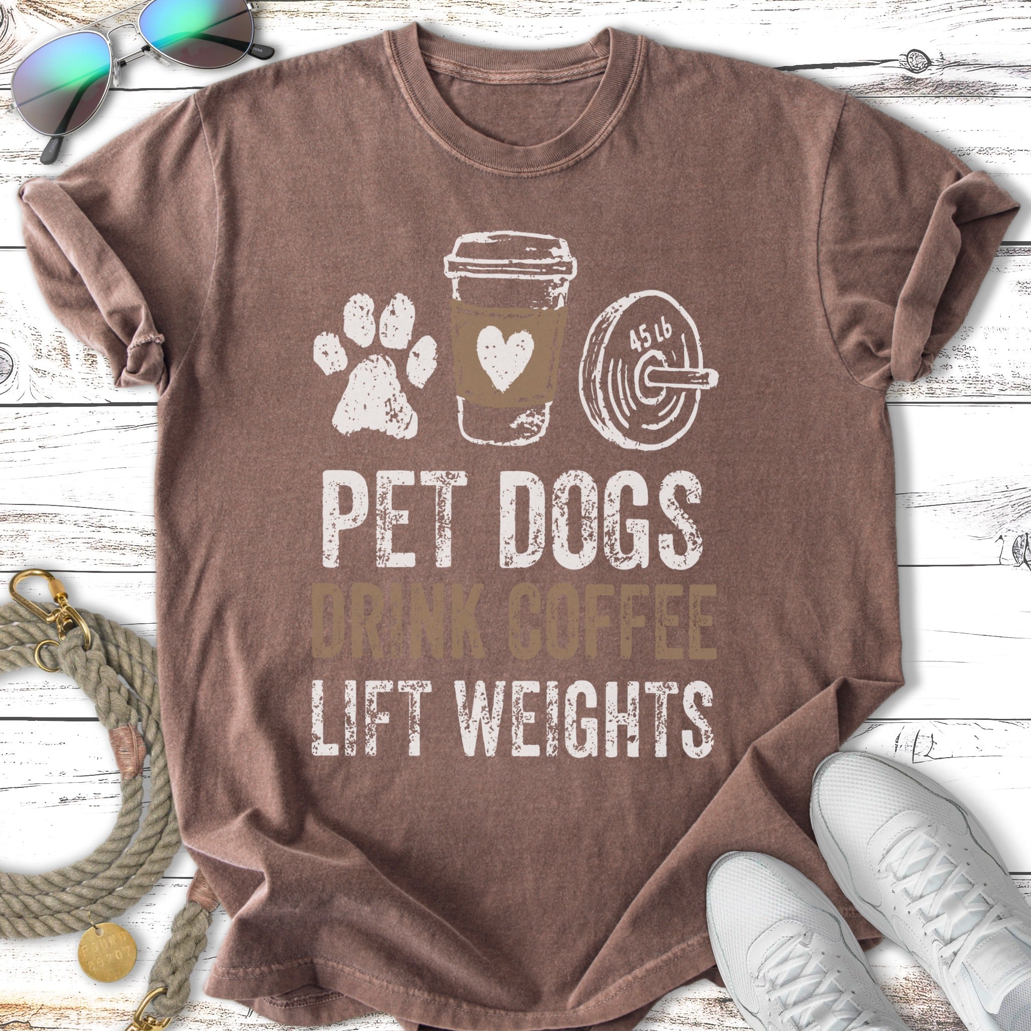 Brown t-shirt with "Pet dogs drink coffee lift weights" graphic.