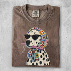 Dalmatian wearing sunglasses and a crochet scarf, holding a crochet hook.