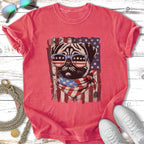 Pug wearing sunglasses and bandana with American flag design.
