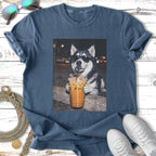Husky wearing sunglasses drinks iced coffee with straw.