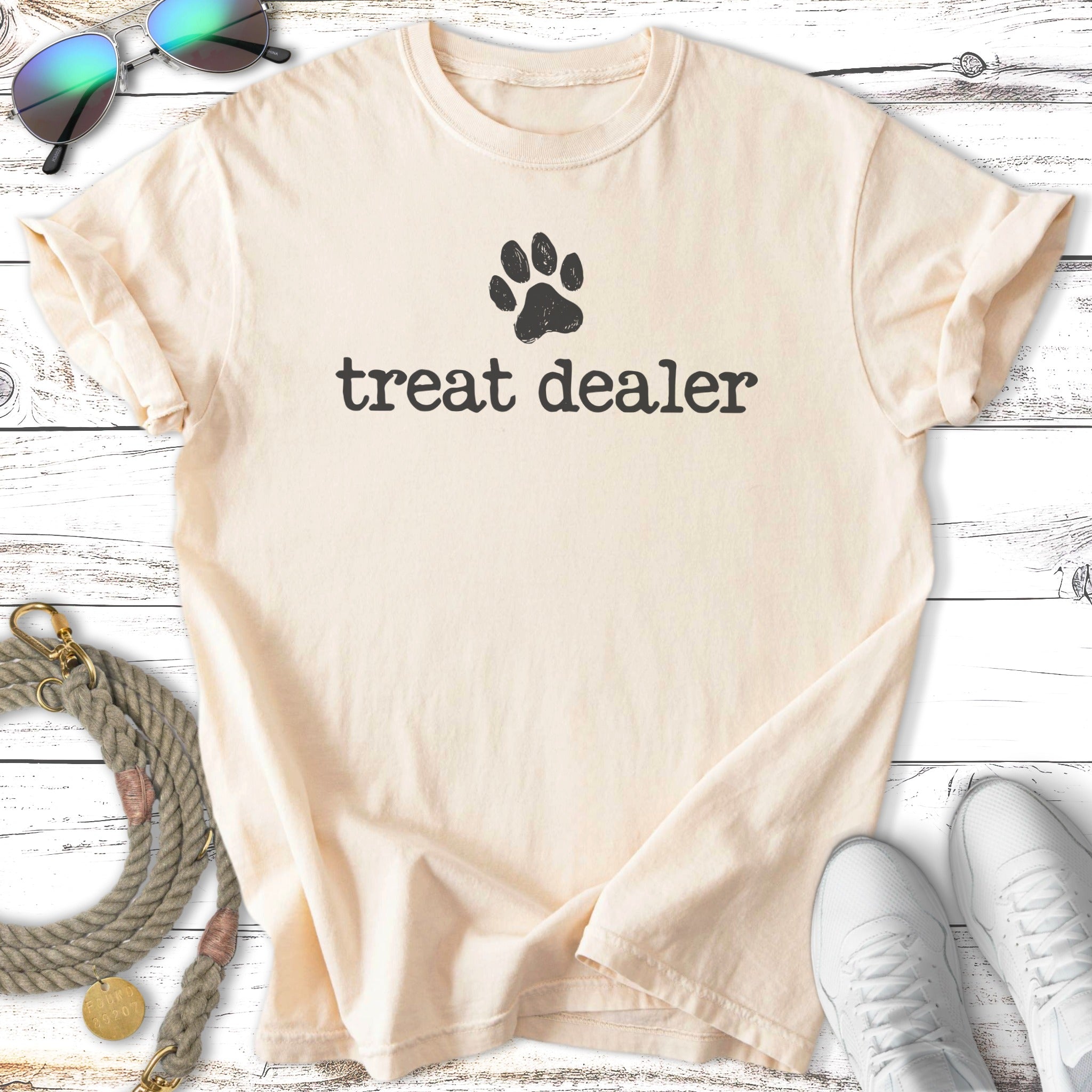 Cream t-shirt with "treat dealer" text and a paw print.