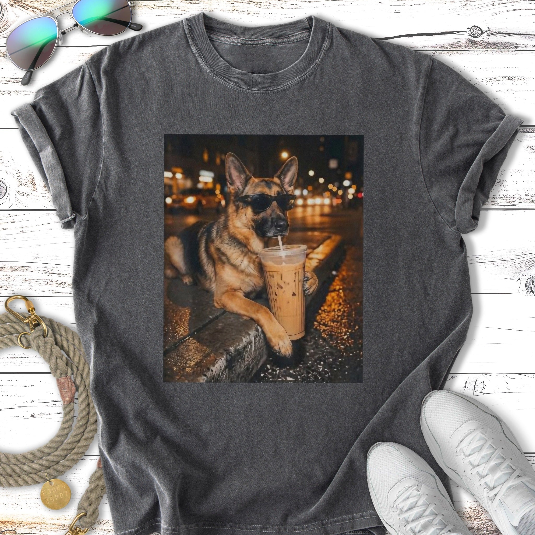 German Shepherd dog wearing sunglasses sips iced coffee in an urban night scene.