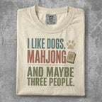 Cream t-shirt with "I Like Dogs, Mahjong, and Maybe Three People" text.