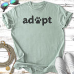 Light green t-shirt with "adopt" and paw print graphic.