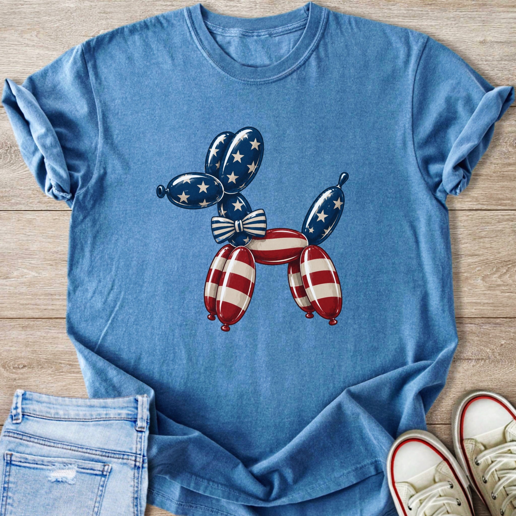 Blue t-shirt with a puffed balloon dog graphic in red and white stripes and blue stars.