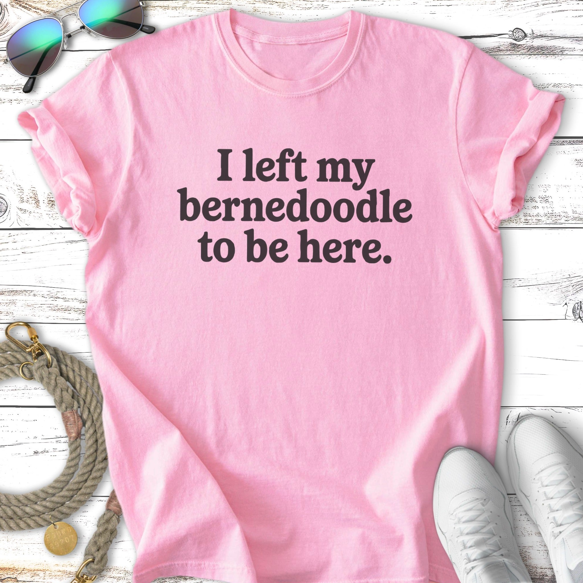 Pink t-shirt with "I left my Bernedoodle to be here." text.