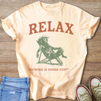 Peach t-shirt with "RELAX" and a dog sitting in a lounge chair.