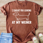 Brown t-shirt with white dachshund graphic and text "I CAUGHT YOU LOOKING AT MY WEINER".