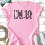 Pink t-shirt with "I'm 10 in dog years" text and paw prints.
