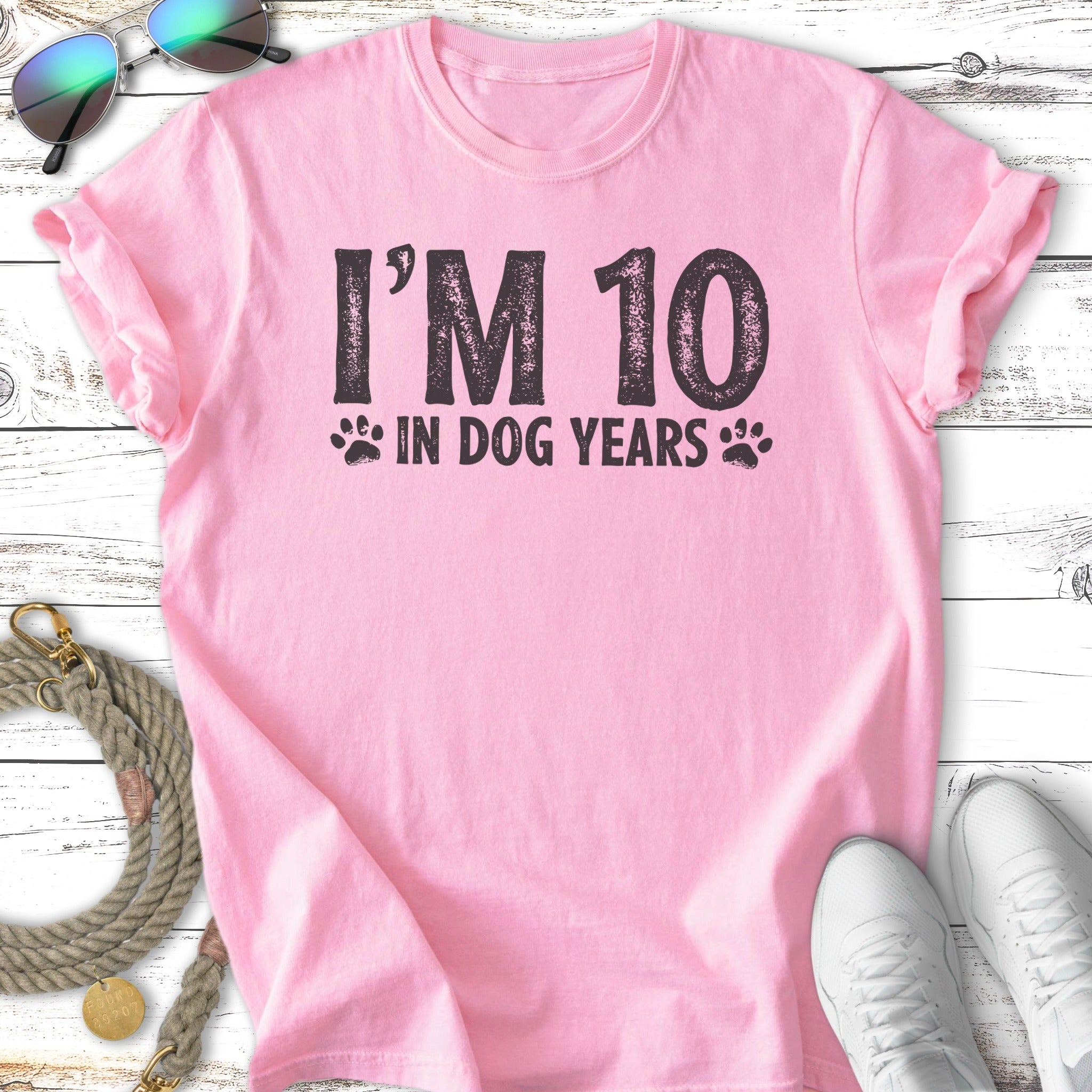 Pink t-shirt with "I'm 10 in dog years" text and paw prints.