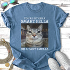 Blue t-shirt with text "You're Either A Smart Fella Or A Fart Smella" and a cat's face.