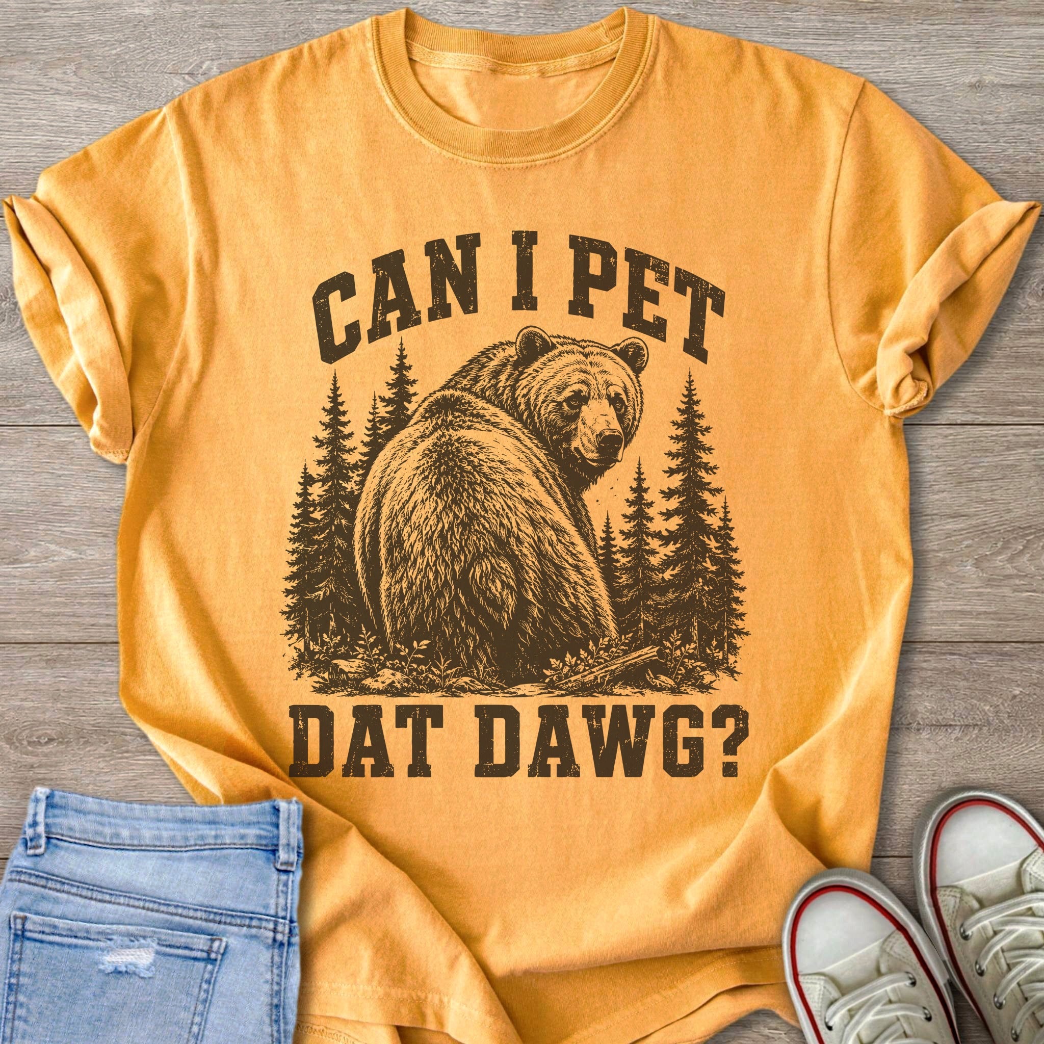 Yellow t-shirt with a bear and trees graphic that reads "CAN I PET DAT DAWG?".