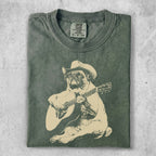 Pug wearing a cowboy hat, playing an acoustic guitar.