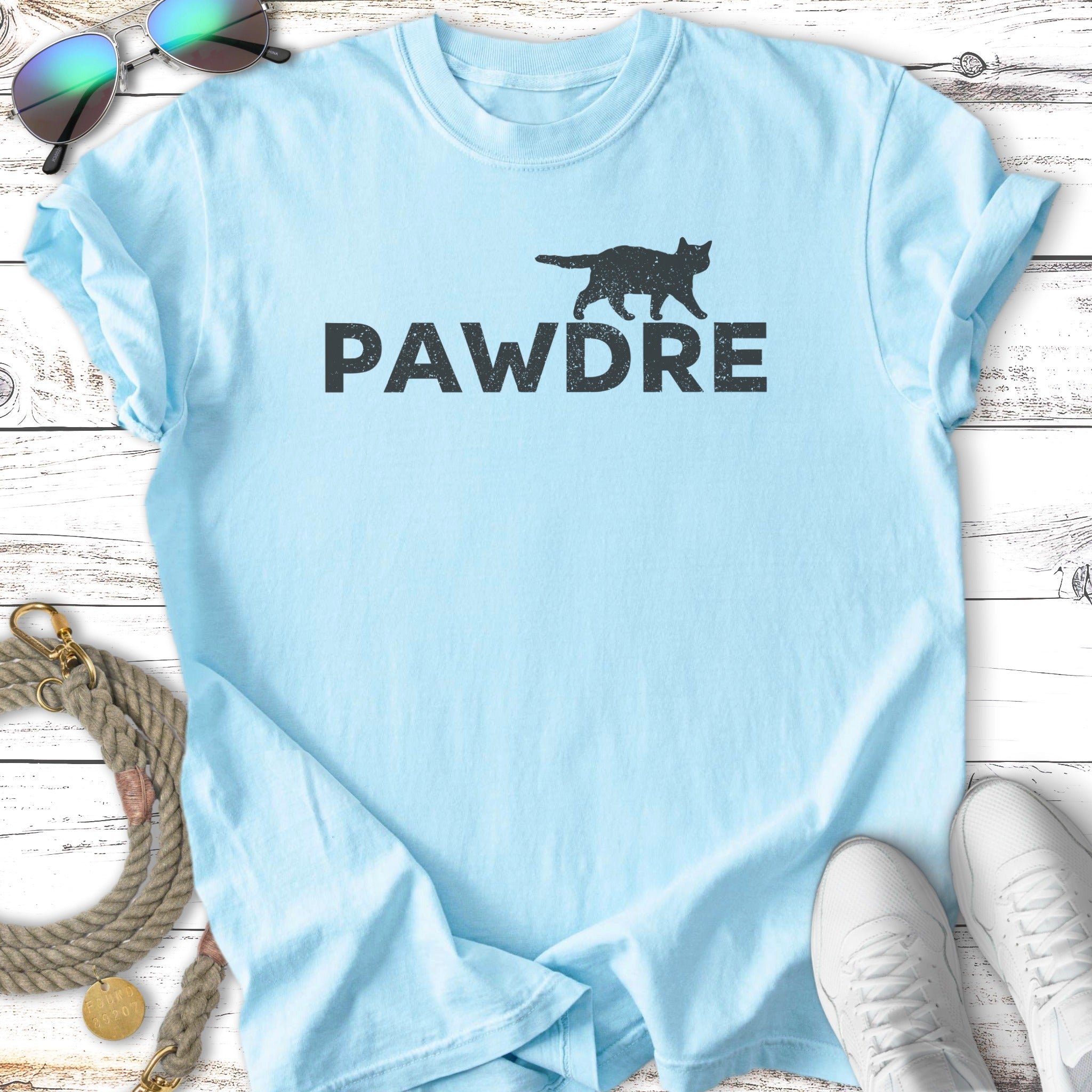 Light blue t-shirt with black cat silhouette and "PAWDRE" text.