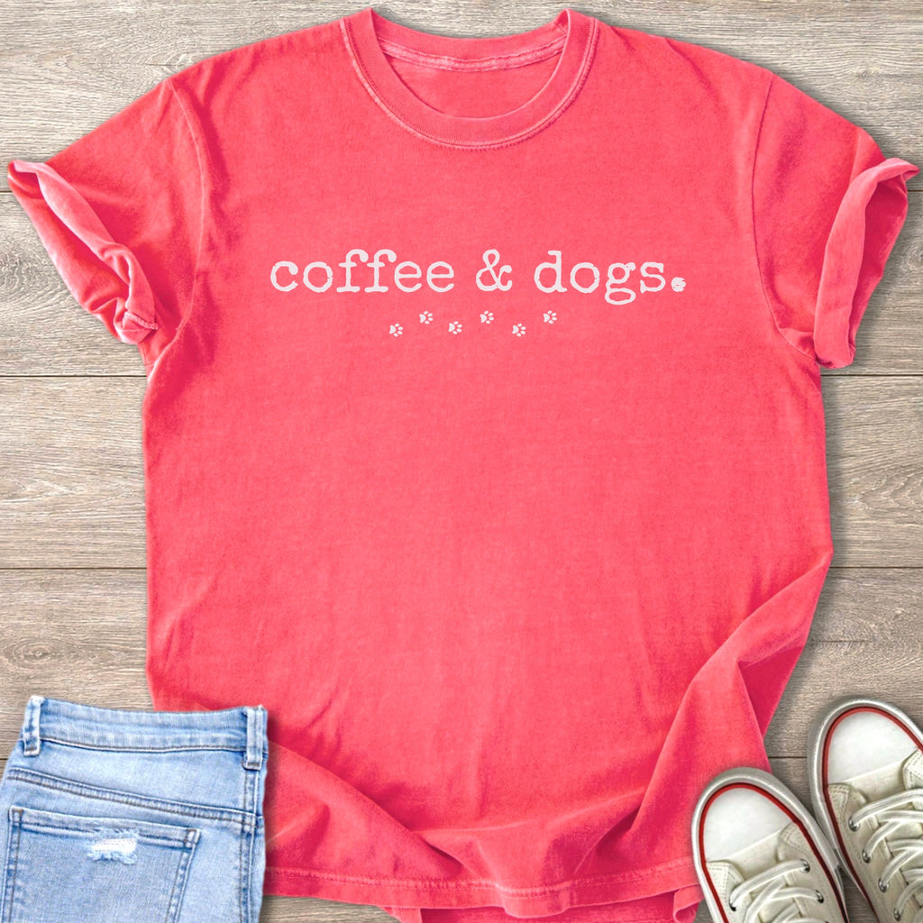 Coral t-shirt with "coffee & dogs" text and paw prints.