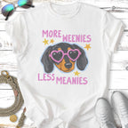 White t-shirt with "More Weenies Less Meanies" text and a dachshund wearing pink heart sunglasses.