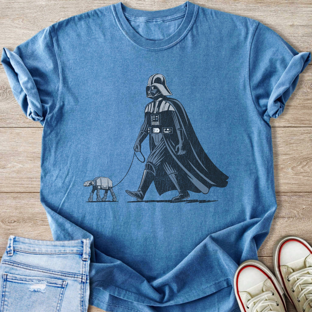 Darth Vader walking an AT-ST walker on a leash, graphic on a blue t-shirt.