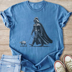 Darth Vader walking an AT-ST walker on a leash, graphic on a blue t-shirt.