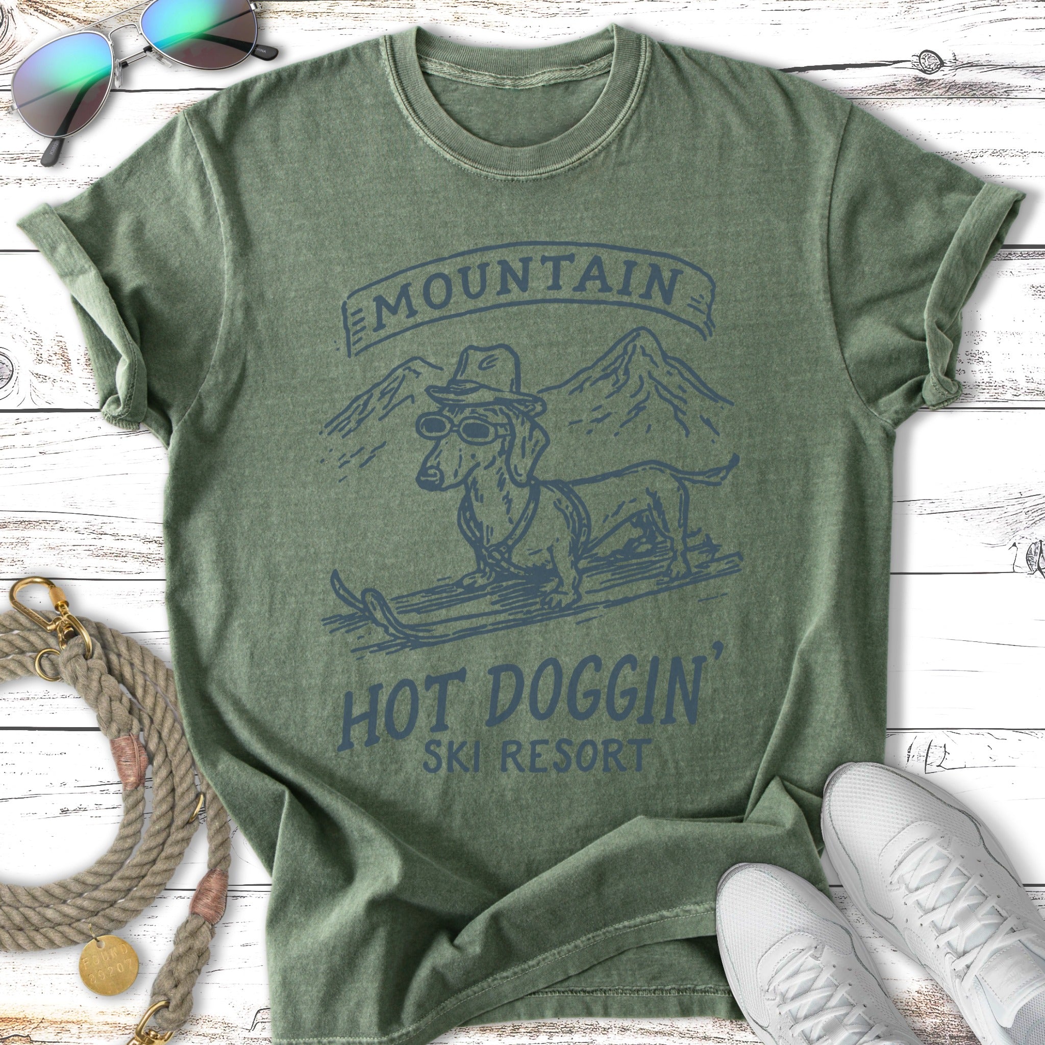 Dachshund wearing sunglasses on skis for "Hot Doggin' Ski Resort".