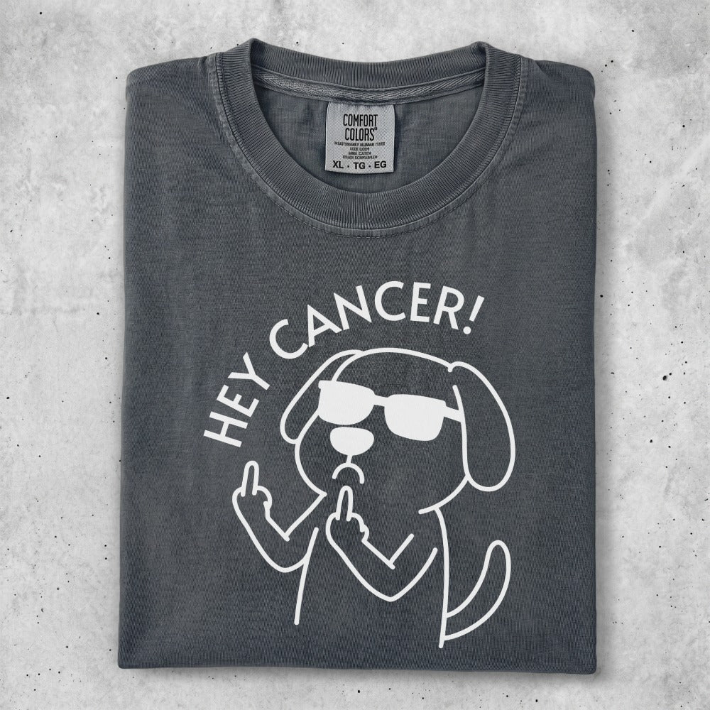 Dog wearing sunglasses gives middle finger with text "HEY CANCER!".