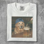 Golden retriever wearing a blue hat drinks beer from a mug.