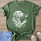 Green t-shirt with a white ink sketch of a dog holding a dandelion.