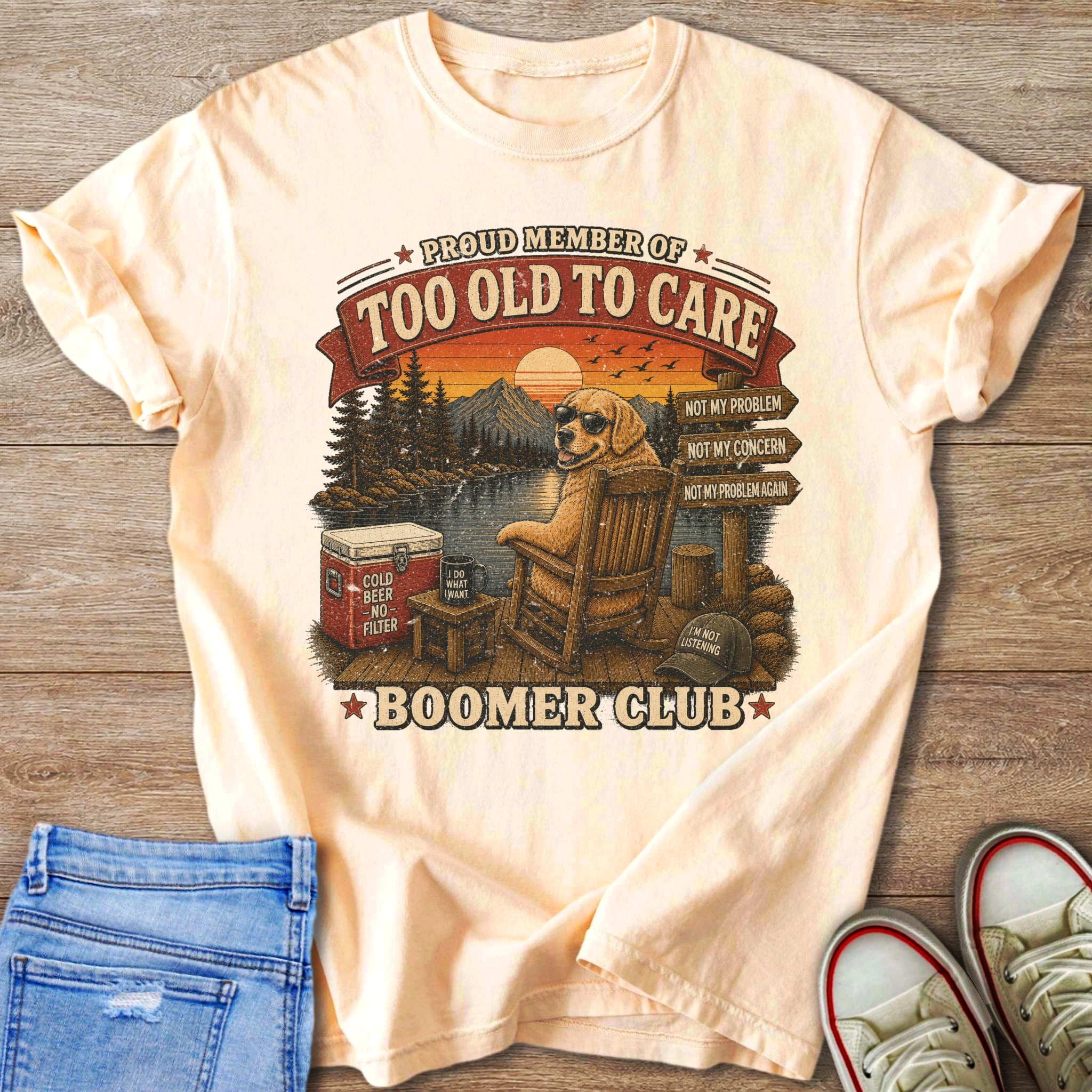 Peach t-shirt with graphic of dog in rocking chair reading "Too Old to Care" and "Boomer Club".