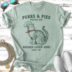 Cat wearing chef hat, "Purrs & Pies Pizza Co. Whiskers Licken' Good" text.