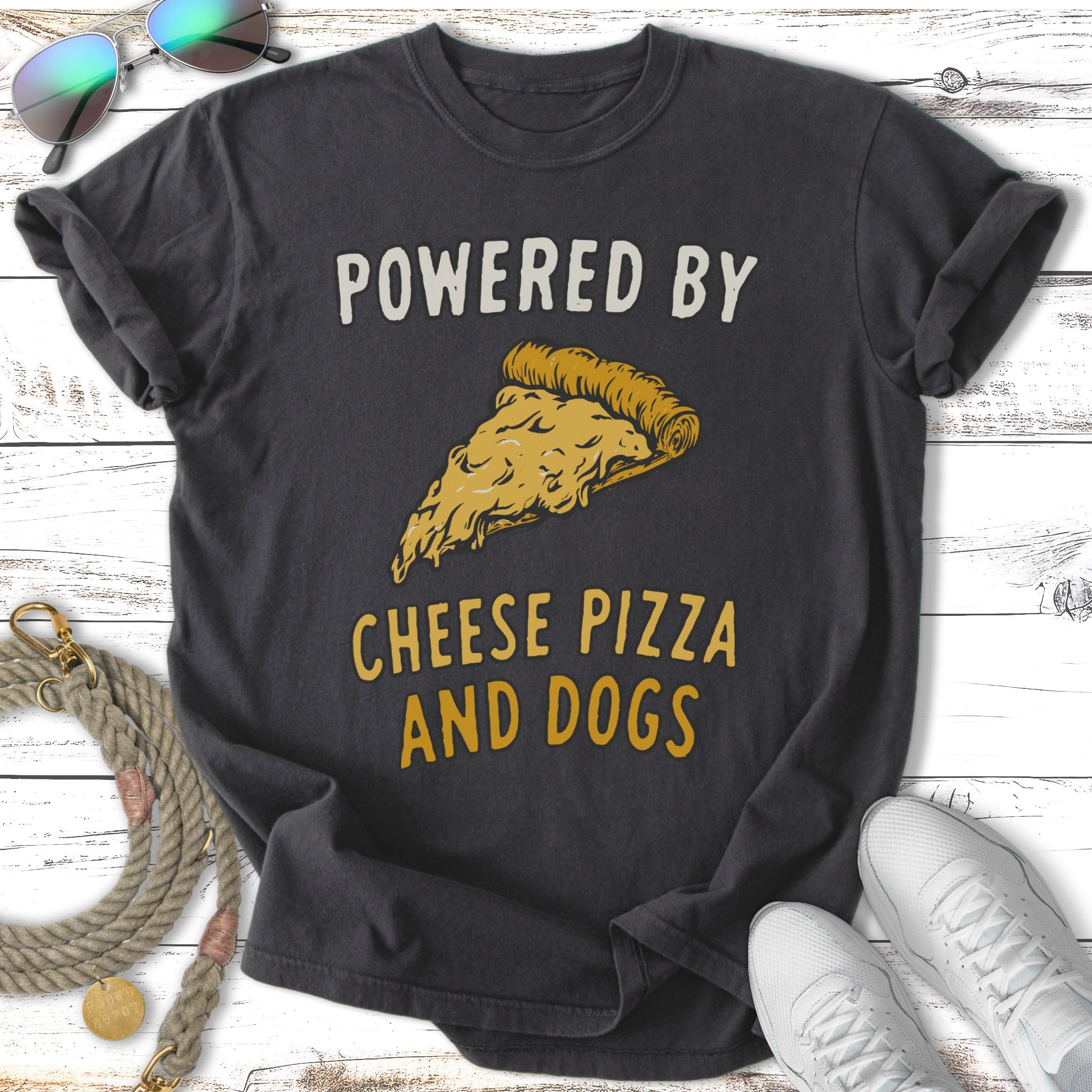 Dark t-shirt with "POWERED BY CHEESE PIZZA AND DOGS" and a slice of pizza.