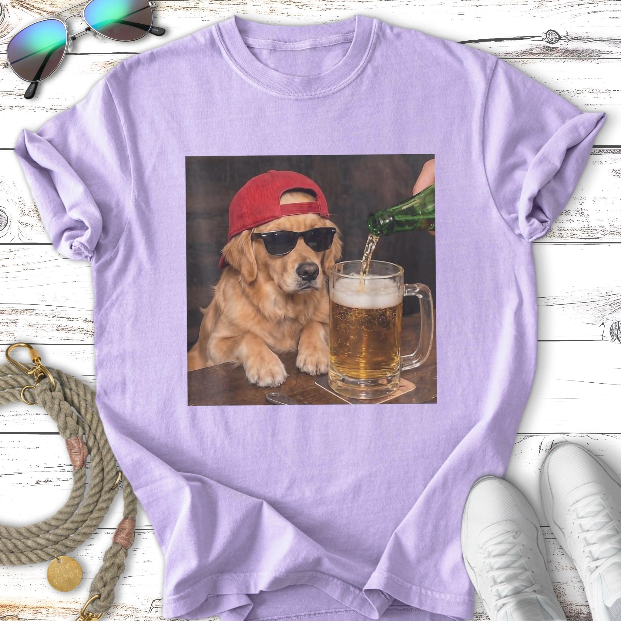 Golden retriever wearing sunglasses and red cap, drinking beer.